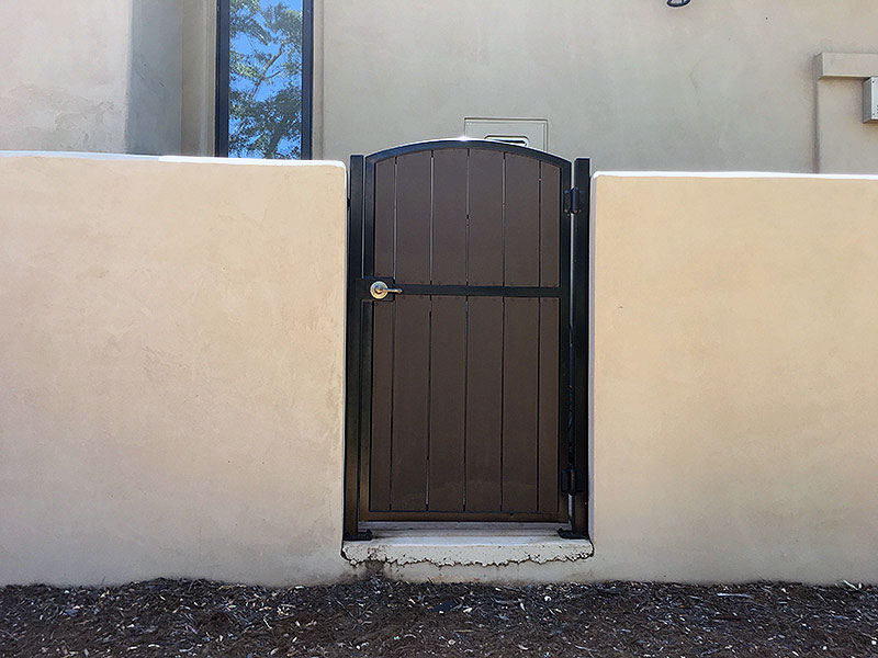 Iron Fence Gate Construction Iron gate with concrete walls for residential property