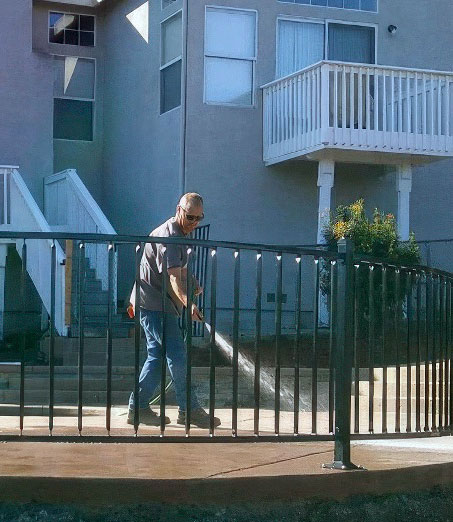 Scott Gregory hosing off the concrete